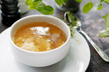 Homemade chicken broth with noodles. Appetizing soup. Suggestion to serve the dish. Culinary photography.