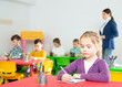 © JackF - Portrait of assiduous little girl with pen and notebook at lesson in elementary school