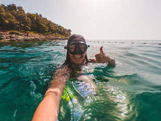 Wall Mural - young pretty smiling woman taking selfie in snorkeling mask