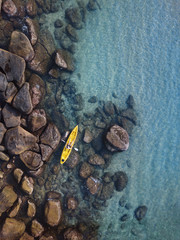 Wall Mural - adventure travel, kayaking on tropical beach, man paddling on kayak aerial top down view from above