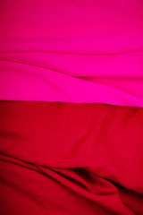 Closeup folds of pink and red or drapery (with copyspace for text)