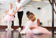 © JackF - Little upset girl in pink tutu sitting on floor in ballet class
