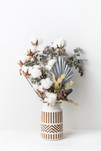 Beautiful Dried Flower Arrangement In A Stylish Ceramic White Vase With Brown Aztec Pattern. Dried Flowers Include A Banksia, Silver Palm Leaf, Cotton And Eucalyptus Leaves.