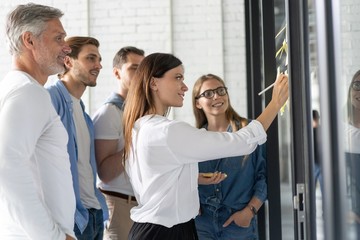 Canvas Print - Business people meeting at office and use post it notes to share idea. Brainstorming concept. Sticky note on glass wall.