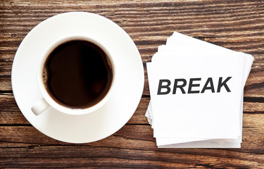 Business BREAK. White stickers with text on the wooden background with coffee