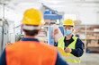 © Karanov images - Worker in a factory wearing protective mask due to pandemic