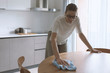 © stokkete - Woman cleaning the kitchen table with a cloth