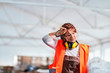 © Karanov images - Portrait of a women worker in a factory on a break, taking off protective wear