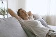 © stokkete - Happy woman lying on the sofa at home and relaxing