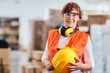 © Karanov images - Portrait of a women worker in a factory wearing protective wear