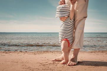 Wall Mural - Little baby boy walking on the beach in summer day