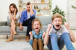 Naughty Children Misbehaving Screaming Sitting Near Exhausted Parents At Home