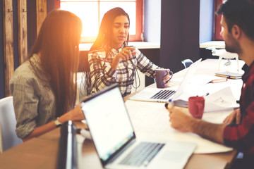 Crew of male and female colleagues working together on project sitting in coworking office