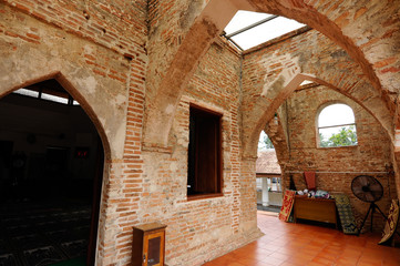 Wall Mural - PATTANI, THAILAND -JULY 10, 2014: Historic Kru Se mosque which is made of bricks with round pillars. The mosque represents a unique Islamic civilization of the Kingdom of Pattani in Thailand.