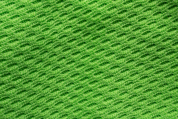 Wall Mural - Green sports clothing fabric football shirt jersey texture close up