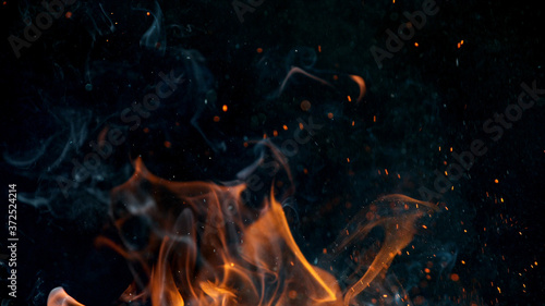 Fotomural fire flames with sparks on a black background, close-up