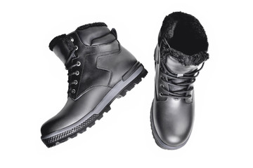 Winter men’s black leather boots on a white background, hiking shoes, practical off-road shoes, close-up