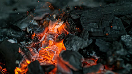 Barbecue Grill Pit With Glowing And Flaming Hot Charcoal Briquettes, Close-Up