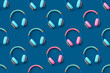 © Veronika - Seamless pattern of blue and pink colored headphones on blue background. Minimalistic fashion music concept. Trendy color of the year concept. Top view, flat lay