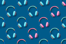Seamless Pattern Of Blue And Pink Colored Headphones On Blue Background. Minimalistic Fashion Music Concept. Trendy Color Of The Year Concept. Top View, Flat Lay