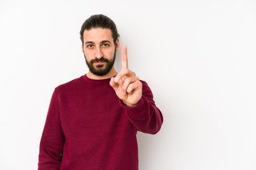 Young long hair man isolated on a white background showing number one with finger.