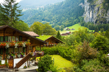 Wall Mural - Lauterbrunnen, Switzerland;  Swiss chalets in the Laturbrennen valley.