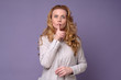 © Viktor Koldunov - Mature woman woman showing a sign of silence gesture putting finger in mouth. Studio shot