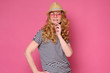 © Viktor Koldunov - Beautiful mature woman wear sunglasses and hat smiling. Enjoy summer holiday isolated on pink background.