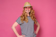 © Viktor Koldunov - Beautiful mature woman wear sunglasses and hat smiling. Enjoy summer holiday isolated on pink background.