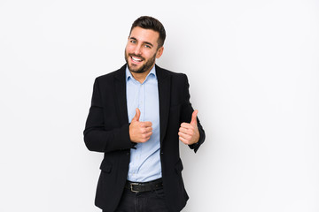 Young caucasian business man against a white background isolated raising both thumbs up, smiling and confident.