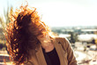 © EDUARDOHUELINPHOTO/Westend61 - Woman tossing red hair during sunny day