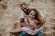 © Gala Martínez López/Westend61 - Daughter sitting on father's lap while playing at beach