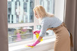 © Angelov - Young woman cleaning the window