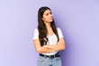 © Asier - Young indian woman isolated on purple background suspicious, uncertain, examining you.