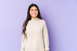 © Asier - Young indian woman isolated on purple background laughs and closes eyes, feels relaxed and happy.
