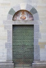 Wall Mural - ancient arched wooden door with metal studs and stone frame