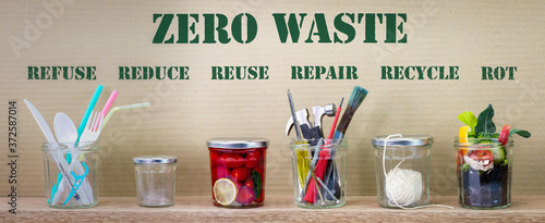 Zero Waste management, illustrated in 6 jars with text Refuse, reduce, recycle, repair, reuse, rot on cardboard background. Sustainable living and eco lifestyle.