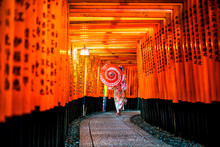 Japanese Girl In Yukata With Red Umbrella At Fushimi Inari Shrine