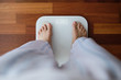 © Antonio Ovejero/ADDICTIVE STOCK - Top view crop faceless barefoot female in cozy pajama standing on digital weight and body fat scales with display showing healthy weight of 60 kg on bathroom floor in morning