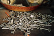 © Javier Ballester/ADDICTIVE STOCK - Heap of various metal keys placed on weathered table in old workshop