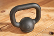 © Philippe Degroote/ADDICTIVE STOCK - From above of cast iron four kilogram kettlebell on wooden floor in light of sun