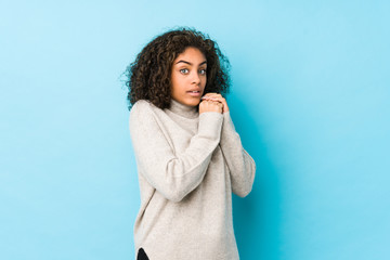 Wall Mural - Young african american curly hair woman scared and afraid.