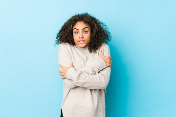 Wall Mural - Young african american curly hair woman going cold due to low temperature or a sickness.