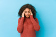 © Asier - Young african american curly hair woman touching temples and having headache.