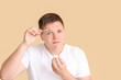 © Pixel-Shot - Teenage boy with remedy for acne on color background