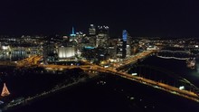 Downtown Pittsburgh Illuminated City Skyline PPG Building At Night Aerial With Water Reflection 4K