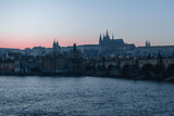 Fototapeta Pomosty - Sunset view of River Vltava, Charles Bridge and Prague Castle in Czech Republic
