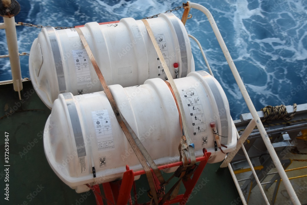Life Raft Cargo Ship Two Liferafts secured with white straps in the red cradle on the cargo ...