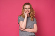 © Viktor Koldunov - Beautiful mature woman in glasses smiling at camera standing against pink background. Studio shot