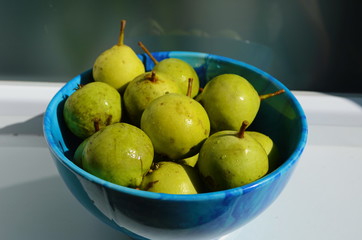 Fresh little pear in the blue plate.